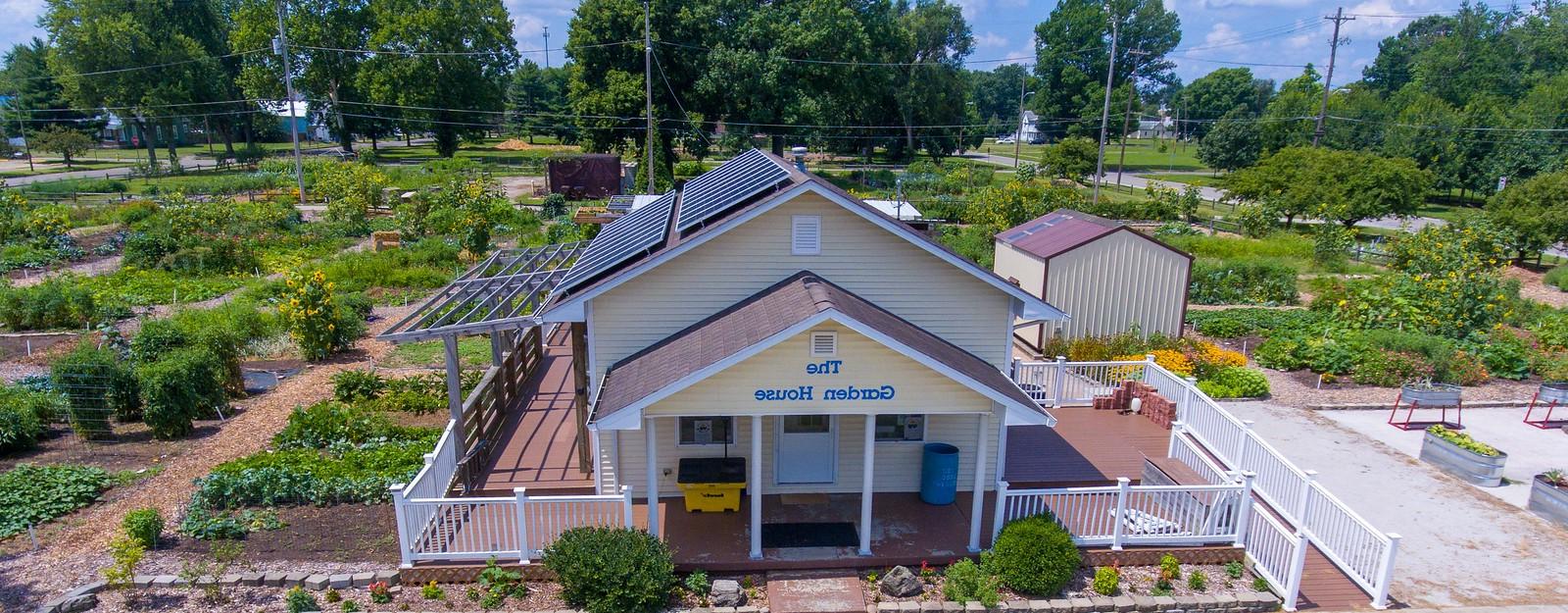 Yellow house with solar panels on the right side of the roof